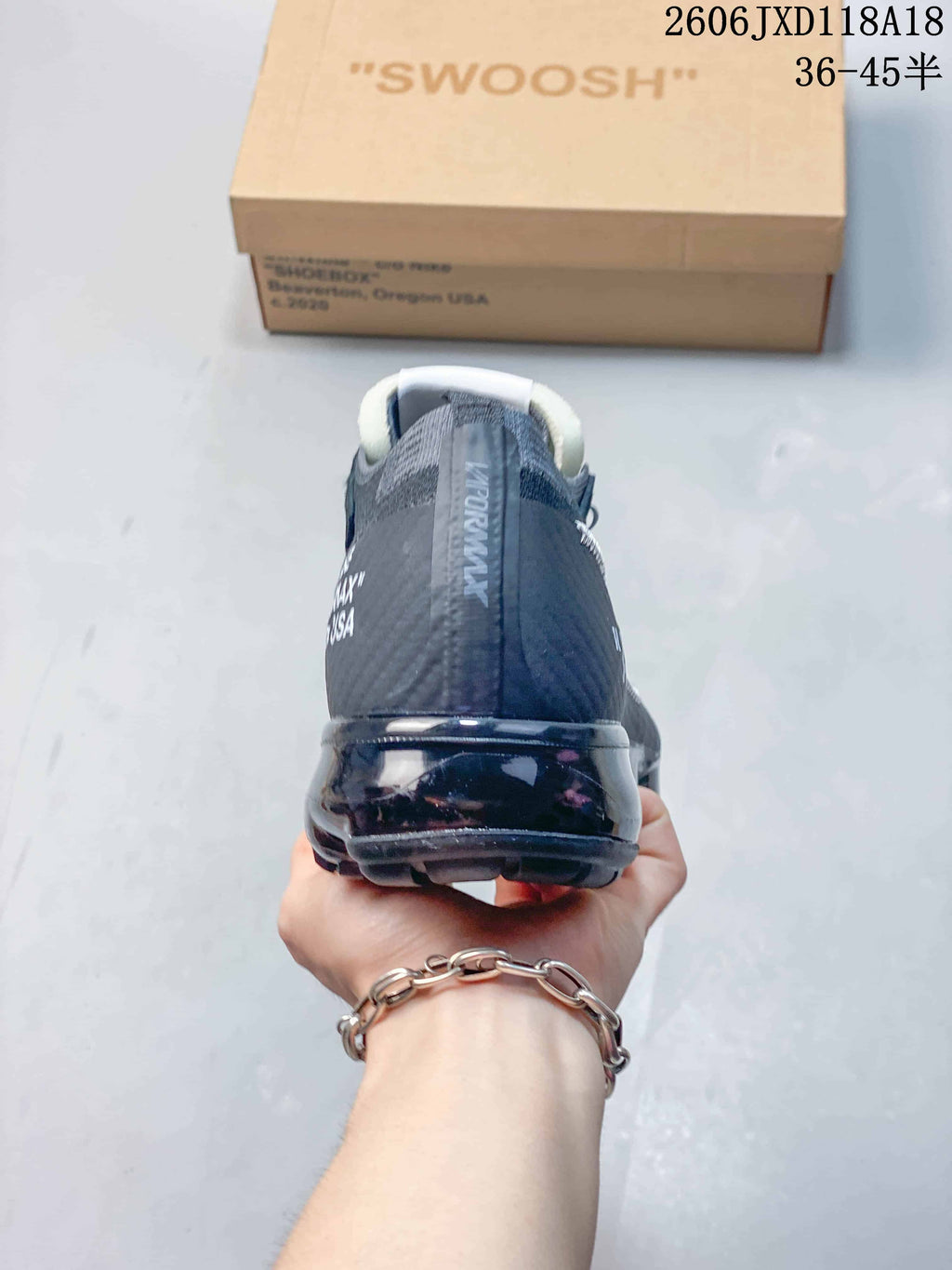 Rear view of a dark gray Nike Air VaporMax sneaker with a translucent heel sole.