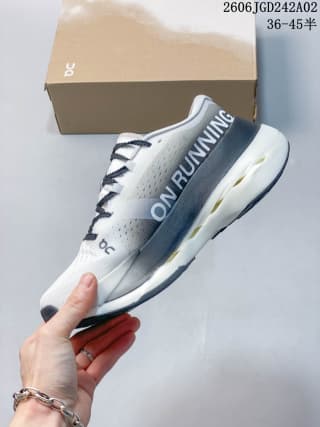 Side view of the ON Cloudboom Max shoe showing the ON RUNNING side branding and layered sole construction.