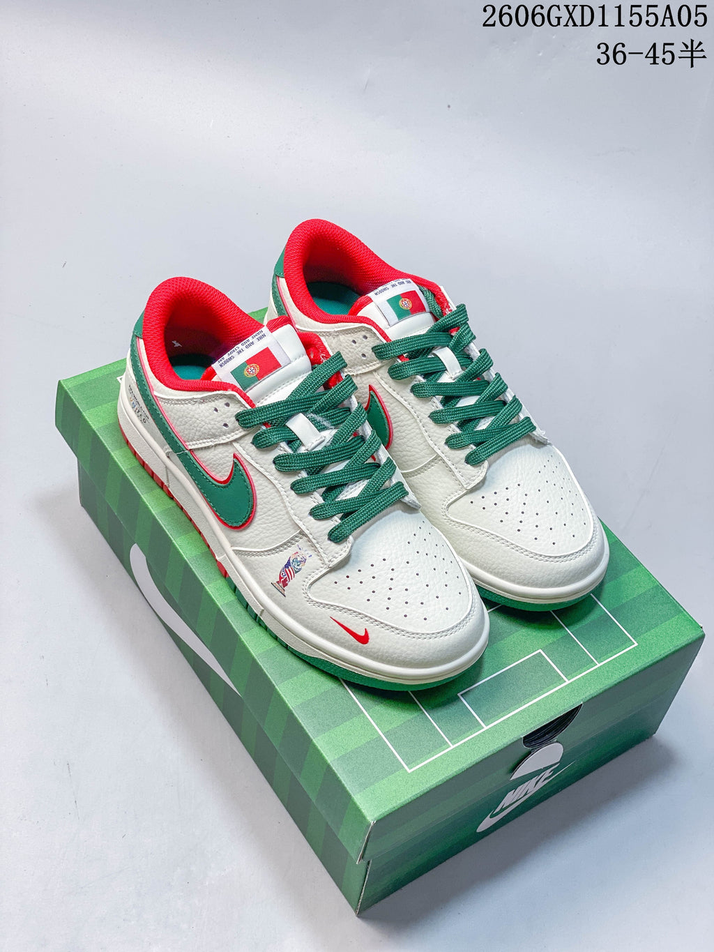 Pair of off-white Dunk-style sneakers with green and red Portugal-inspired details on a green shoe box