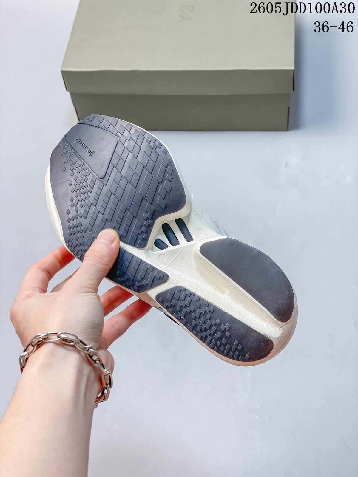 Underside of the running shoe showing the patterned outsole