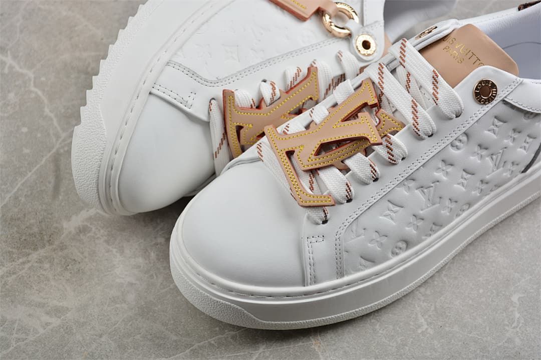 Close-up of the white toe, laces, and raised embossed side panel