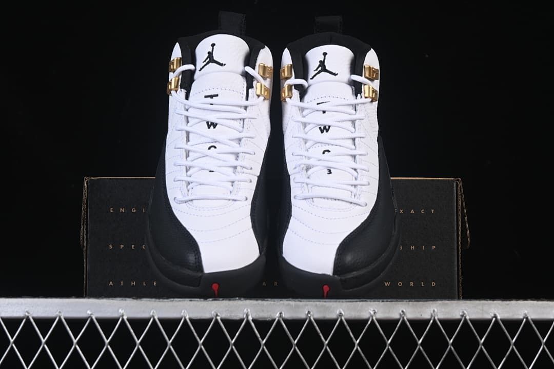 Front view of the pair showing white uppers, black trim and gold-tone lace hardware.