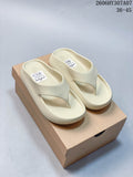 Pair of pale cream Nike Calm Slide thong sandals shown from above