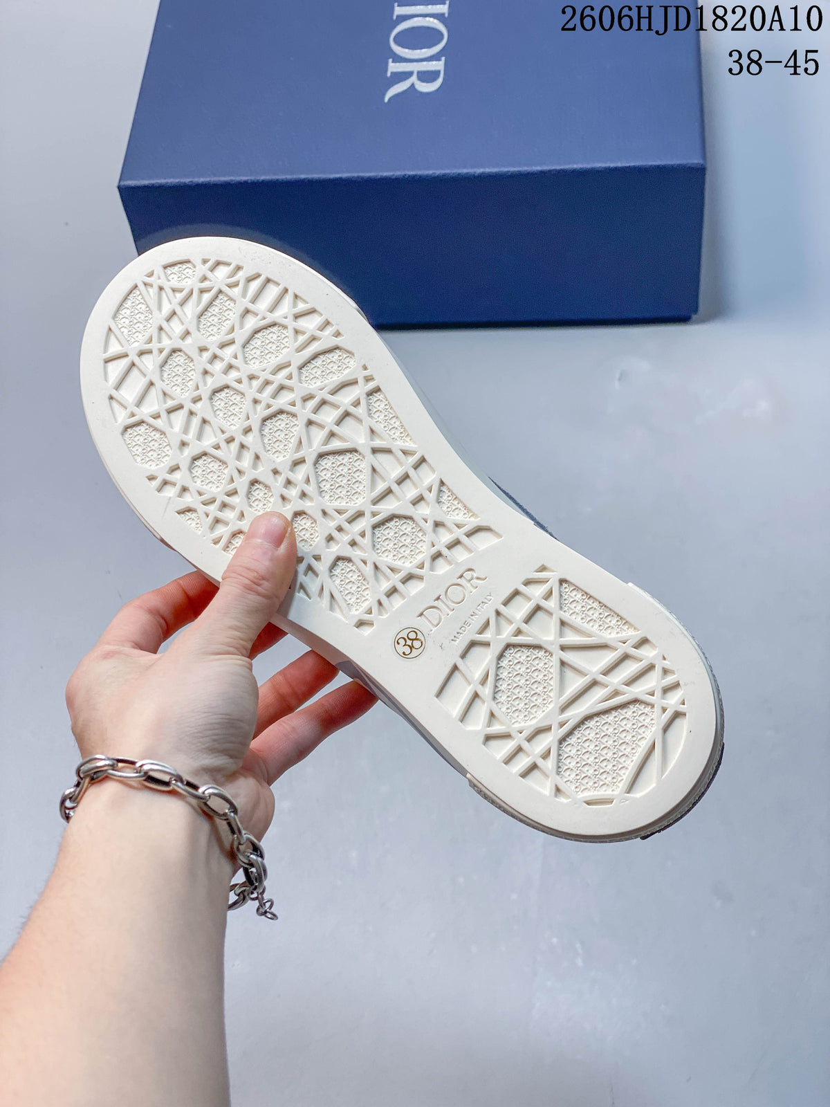 Underside of a sneaker showing a patterned sole and size marking 38