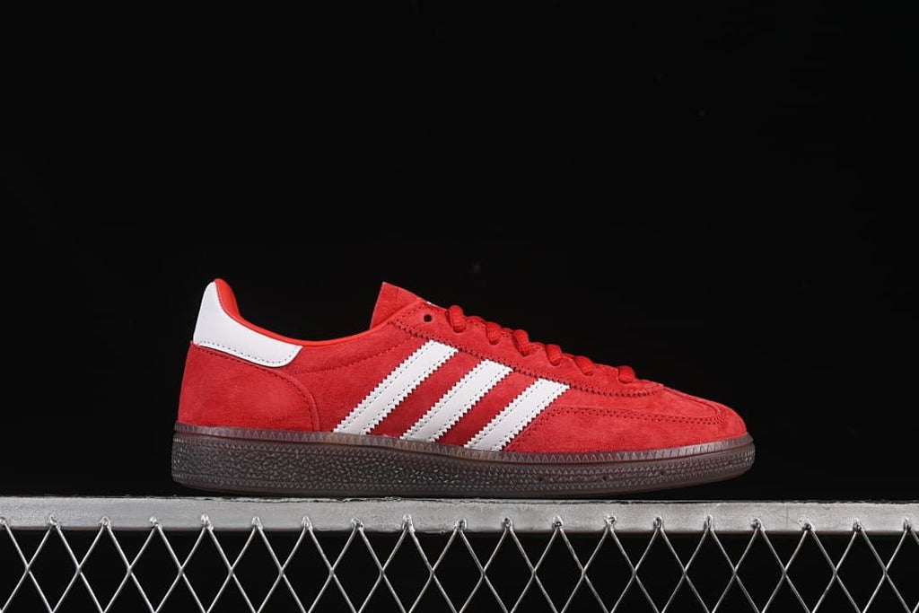 Side profile of the red sneaker with white stripes and dark sole
