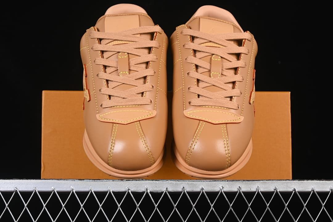 Front view of the pair showing the laces and stitched toe panels