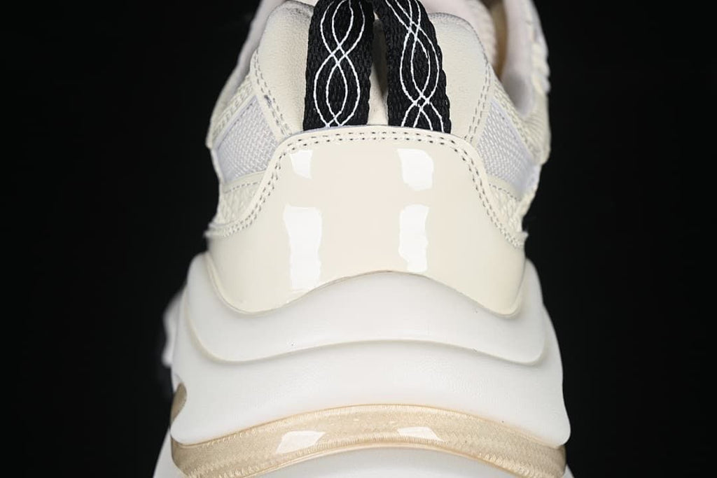 Rear detail of the sneaker with heel pull loops and layered sole