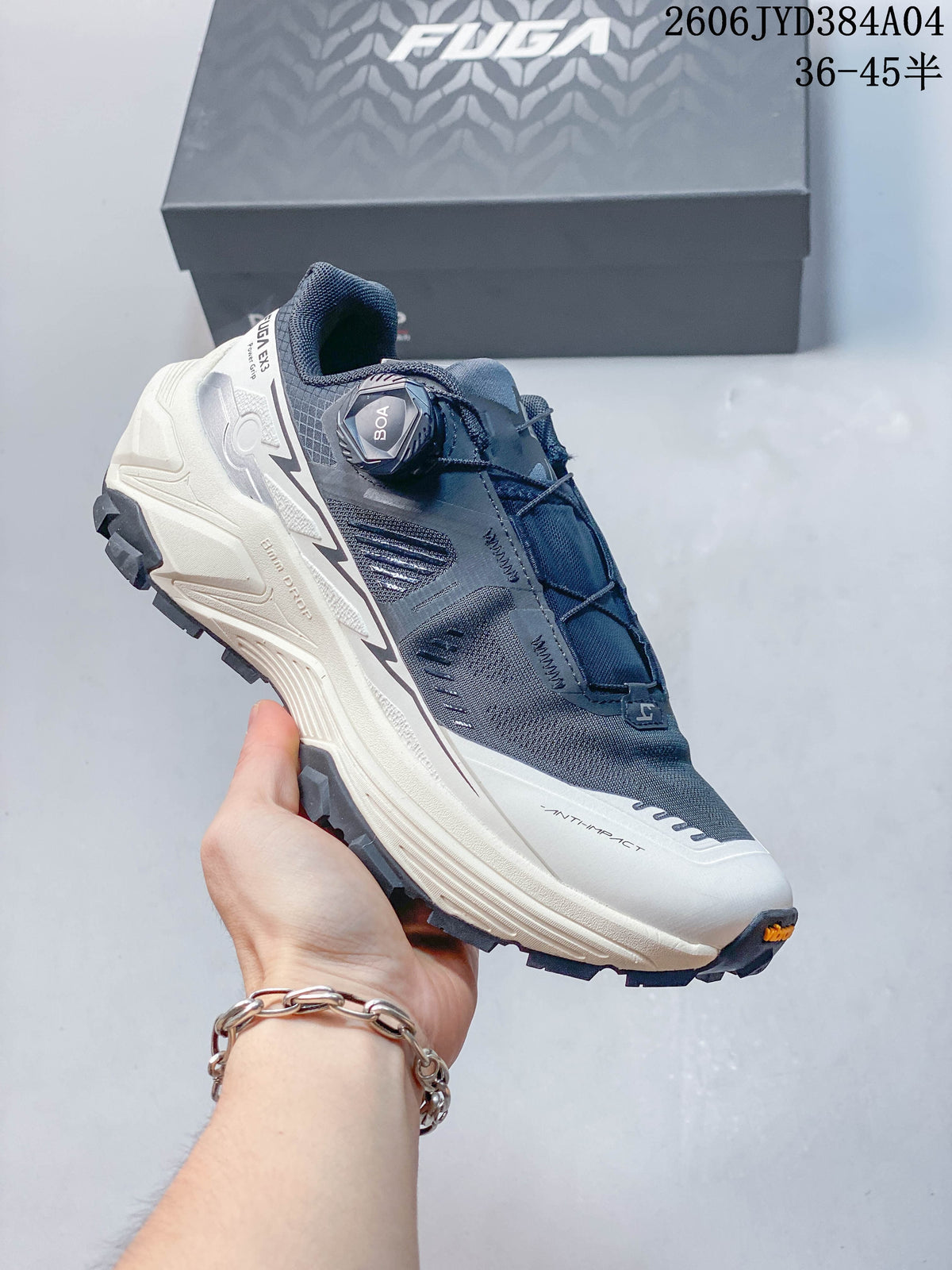 Angled side view of the shoe showing its dial closure and lugged outsole