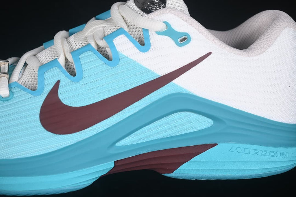 Close-up of the lateral side showing the burgundy Swoosh and embossed Air Zoom marking.