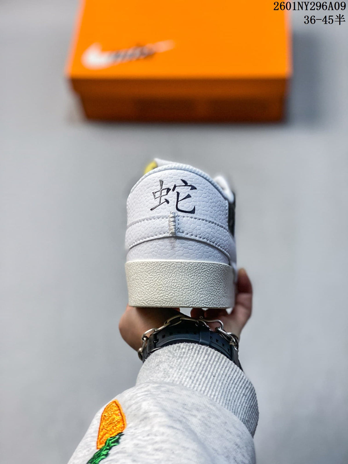 Rear view showing the light-colored heel and dark embroidered detail.