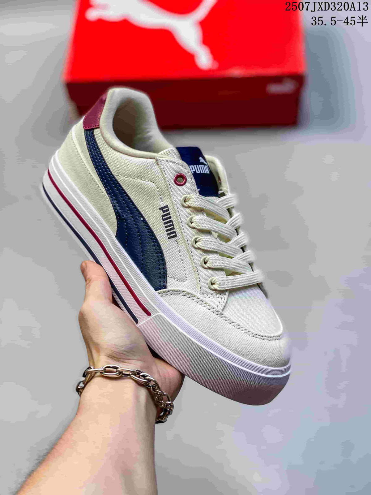 Angled view of a cream PUMA sneaker with a navy side stripe and burgundy heel accent.