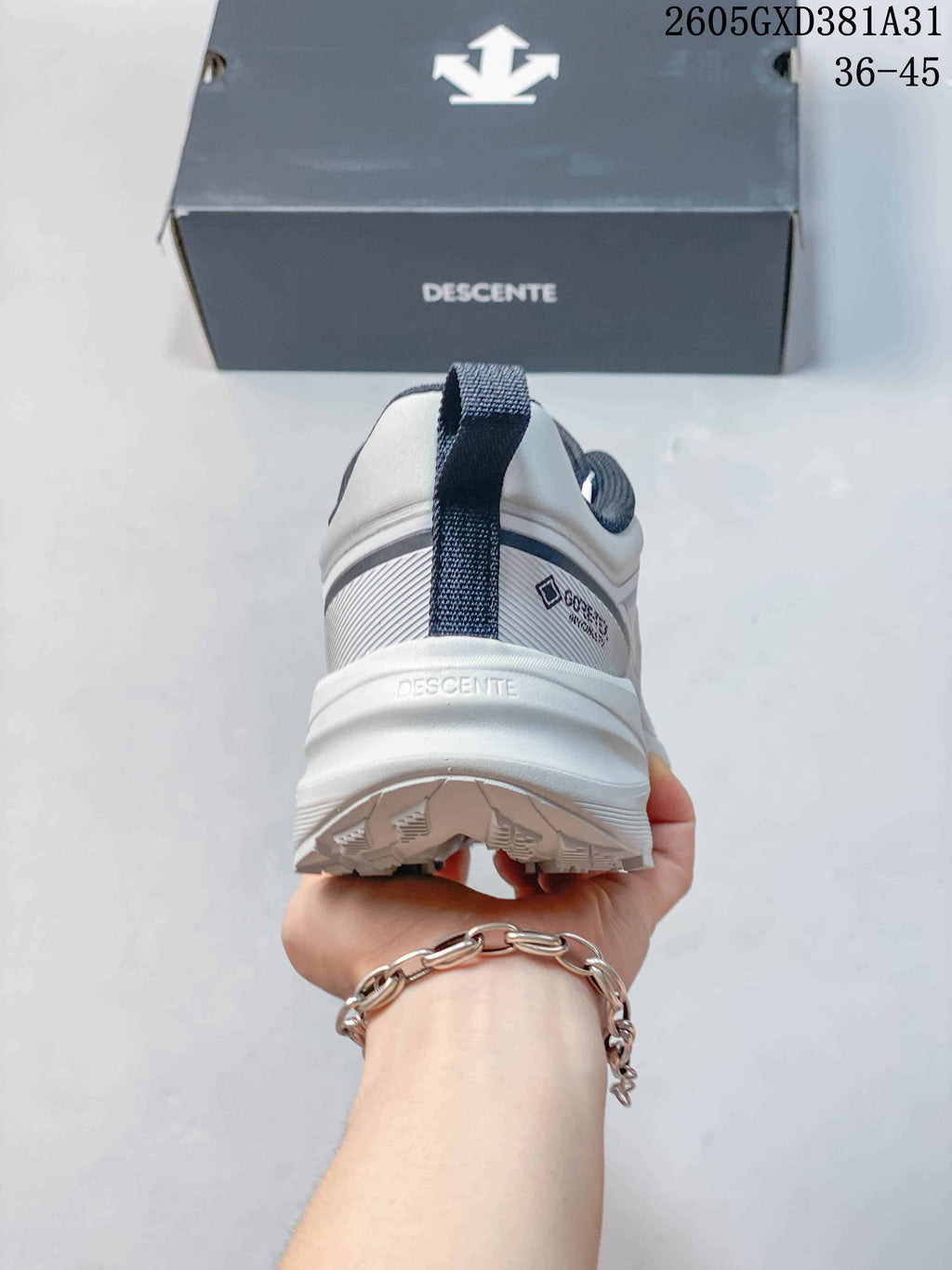Rear view of a Descente sneaker showing the heel loop and outsole
