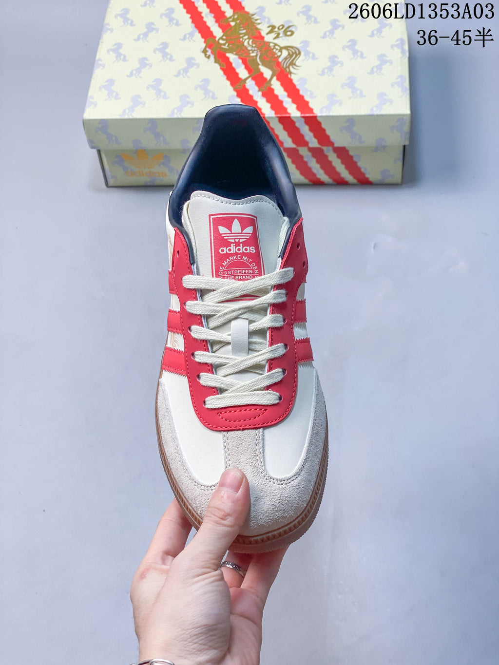 Front view showing the laces, red eyestay and pale textured toe panels