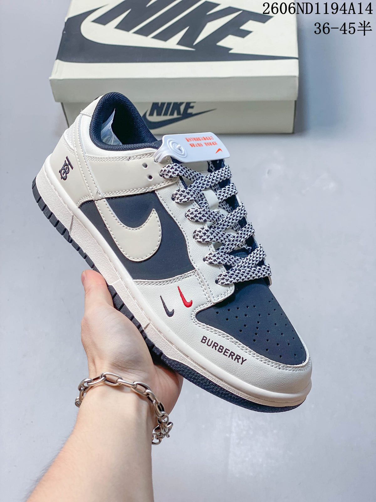 Close view of a navy-and-white low-top sneaker with patterned laces and decorative toe details.