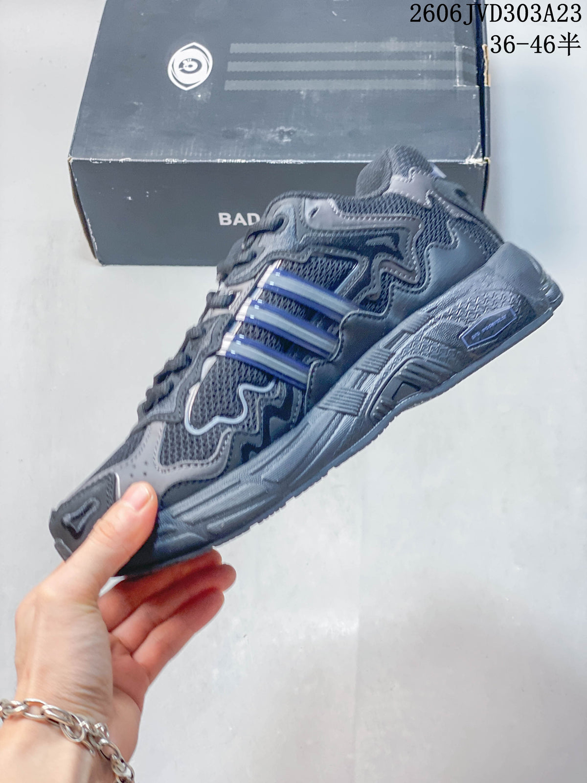 Side view of the sneaker with layered panels and blue-accented stripes