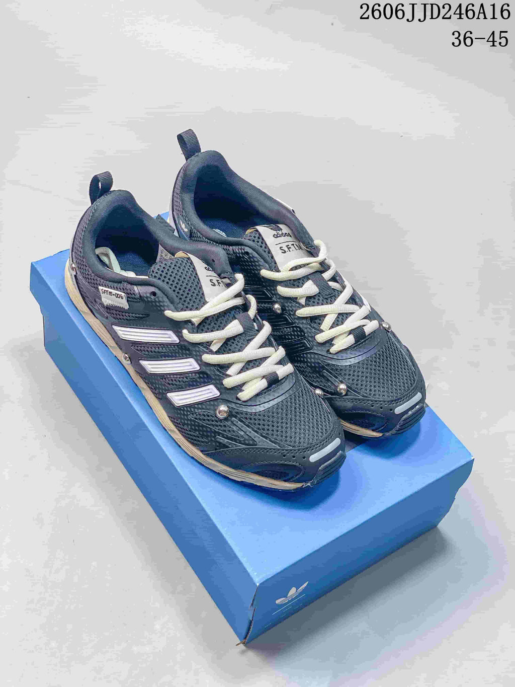 Dark gray Adizero PR SFTM-006 sneakers with cream laces and accents