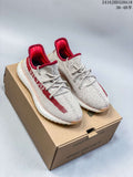Pair of cream and red Adidas Yeezy Boost 350 V2 sneakers on a box