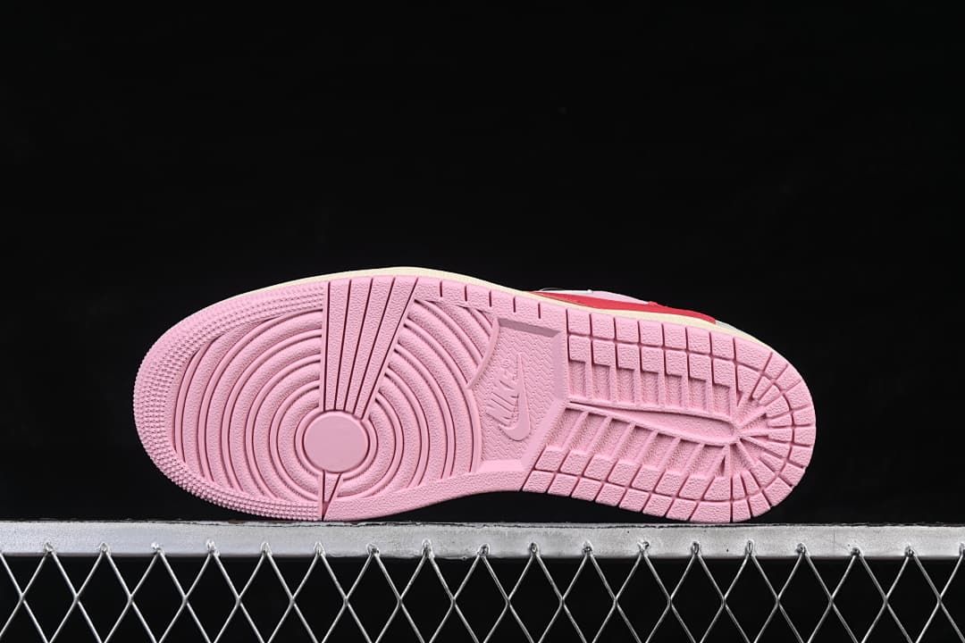 Underside view of the pink outsole tread.