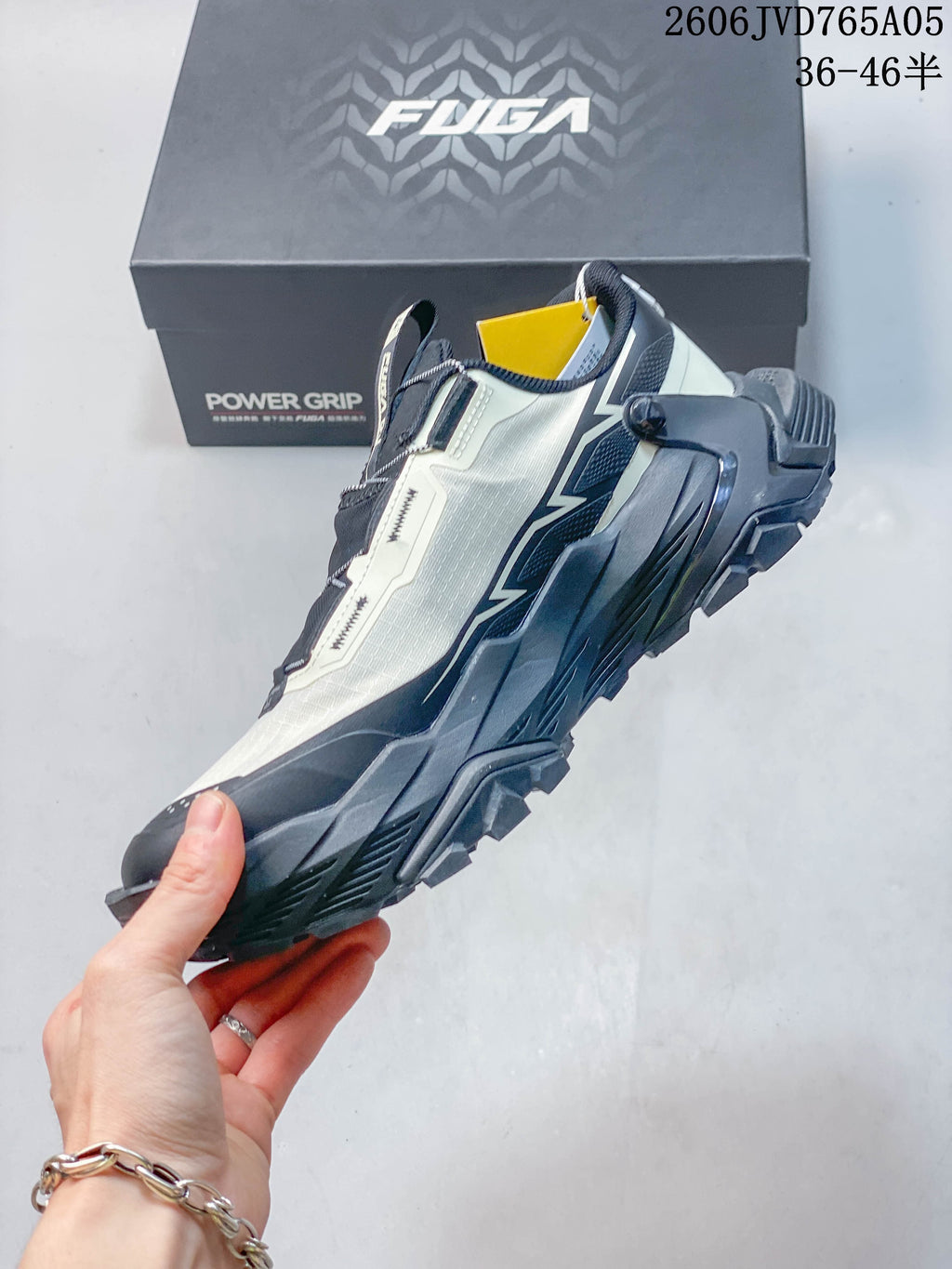 Side view of the low-cut shoe with its dial closure, overlays, and lugged outsole.