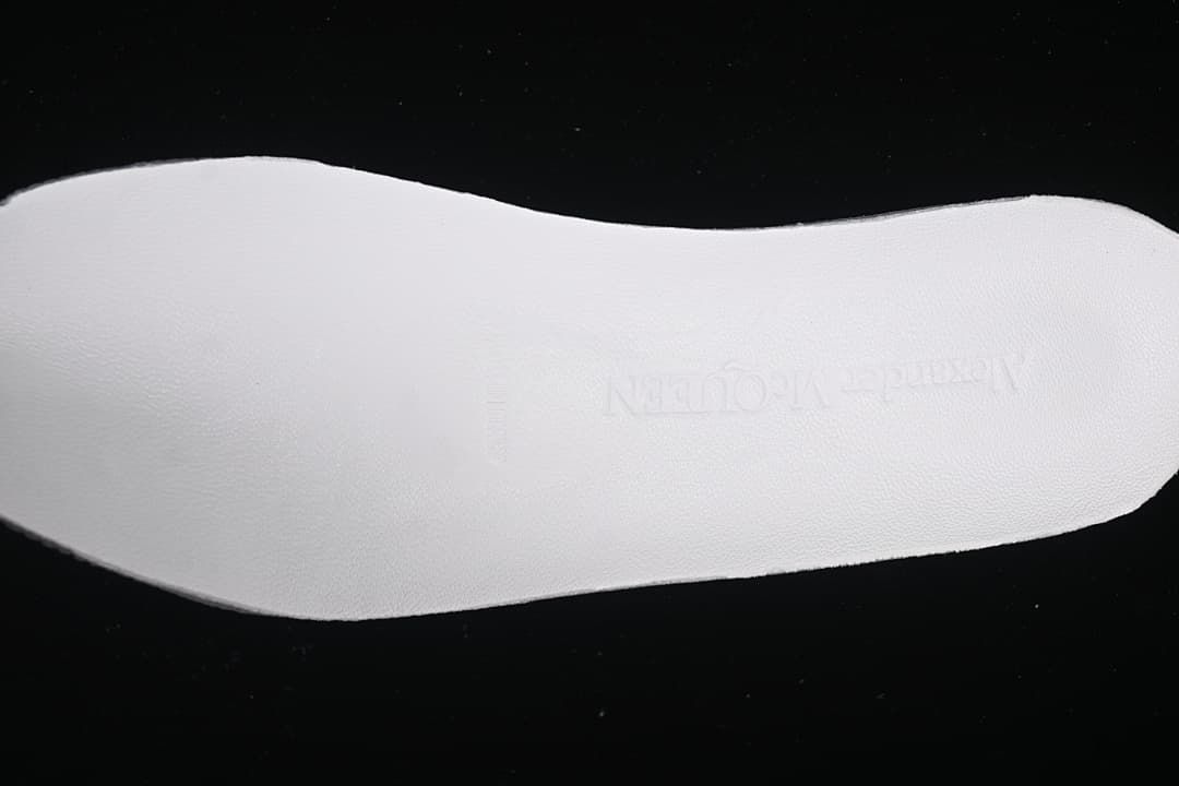 Close view of the white insole with faint Alexander McQueen branding.