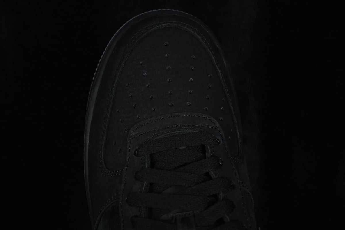 Top-down close-up of the perforated black toe box and black laces.