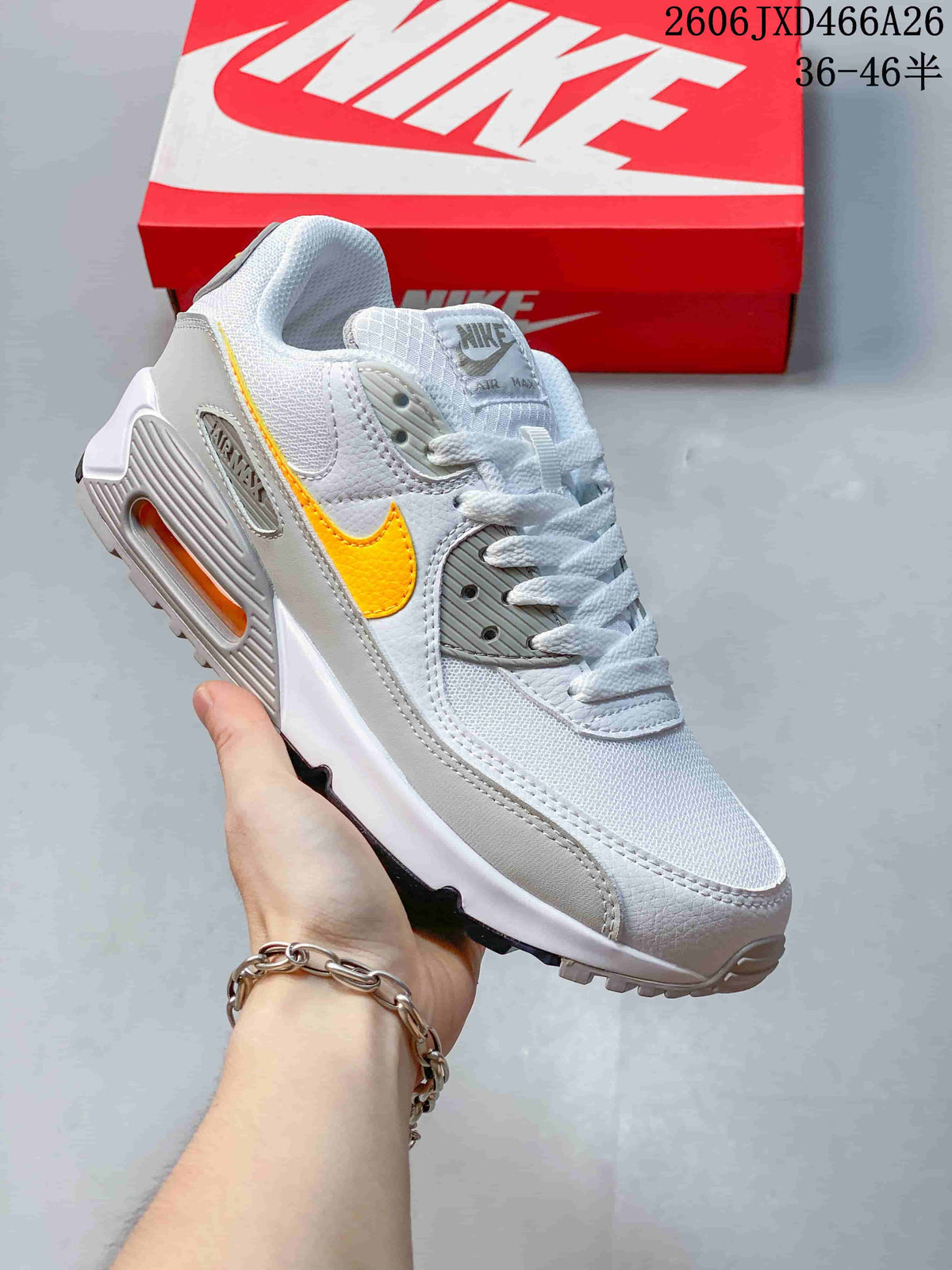 White and gray Nike Air Max 90 sneaker with a yellow Swoosh accent