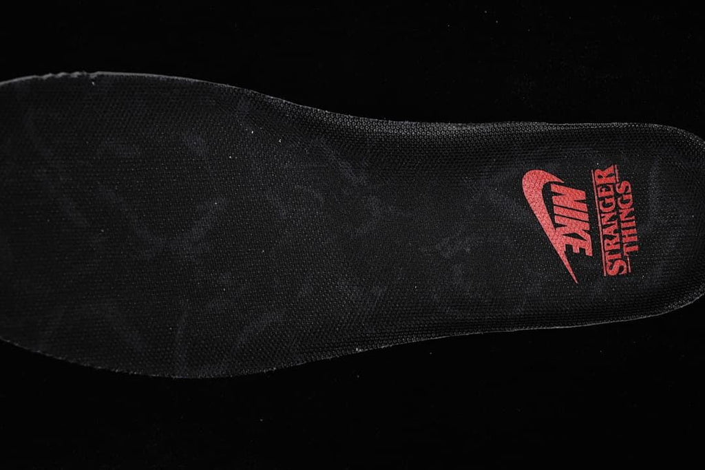 Black insole with red Nike and Stranger Things graphics