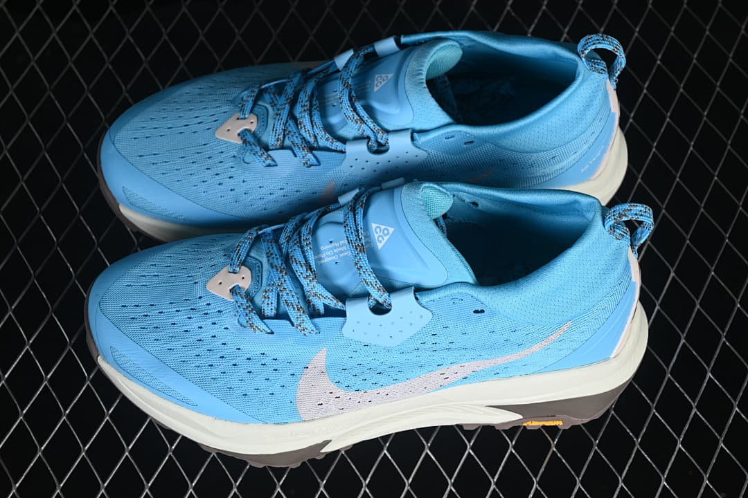 Pair of blue Nike ACG Zegama Trail shoes shown from above and the side.