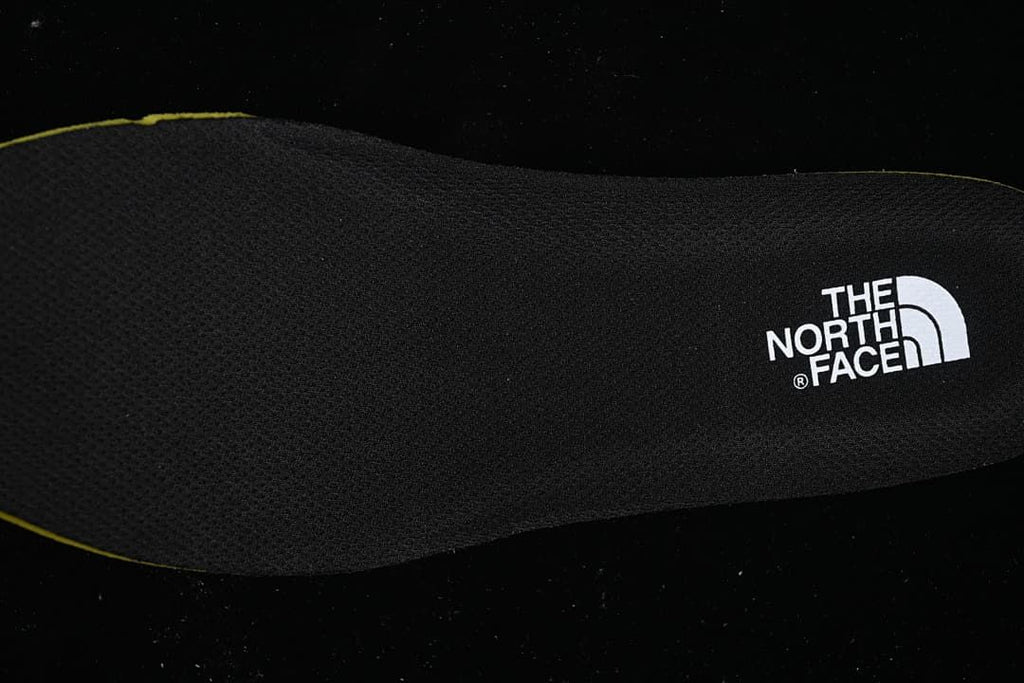Black insole with The North Face logo and a yellow edge
