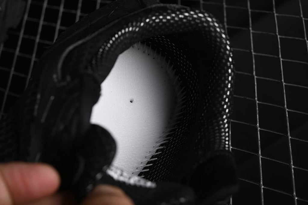 Close-up view inside the sneaker around the insole and padded collar.