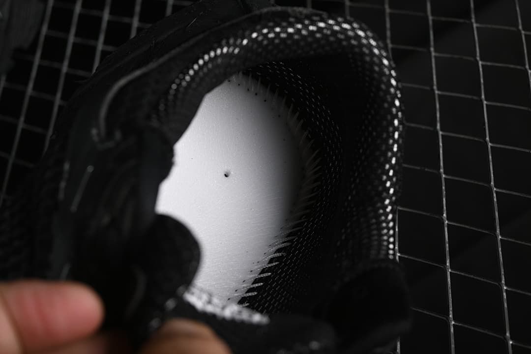 Close-up view inside the sneaker around the insole and padded collar.