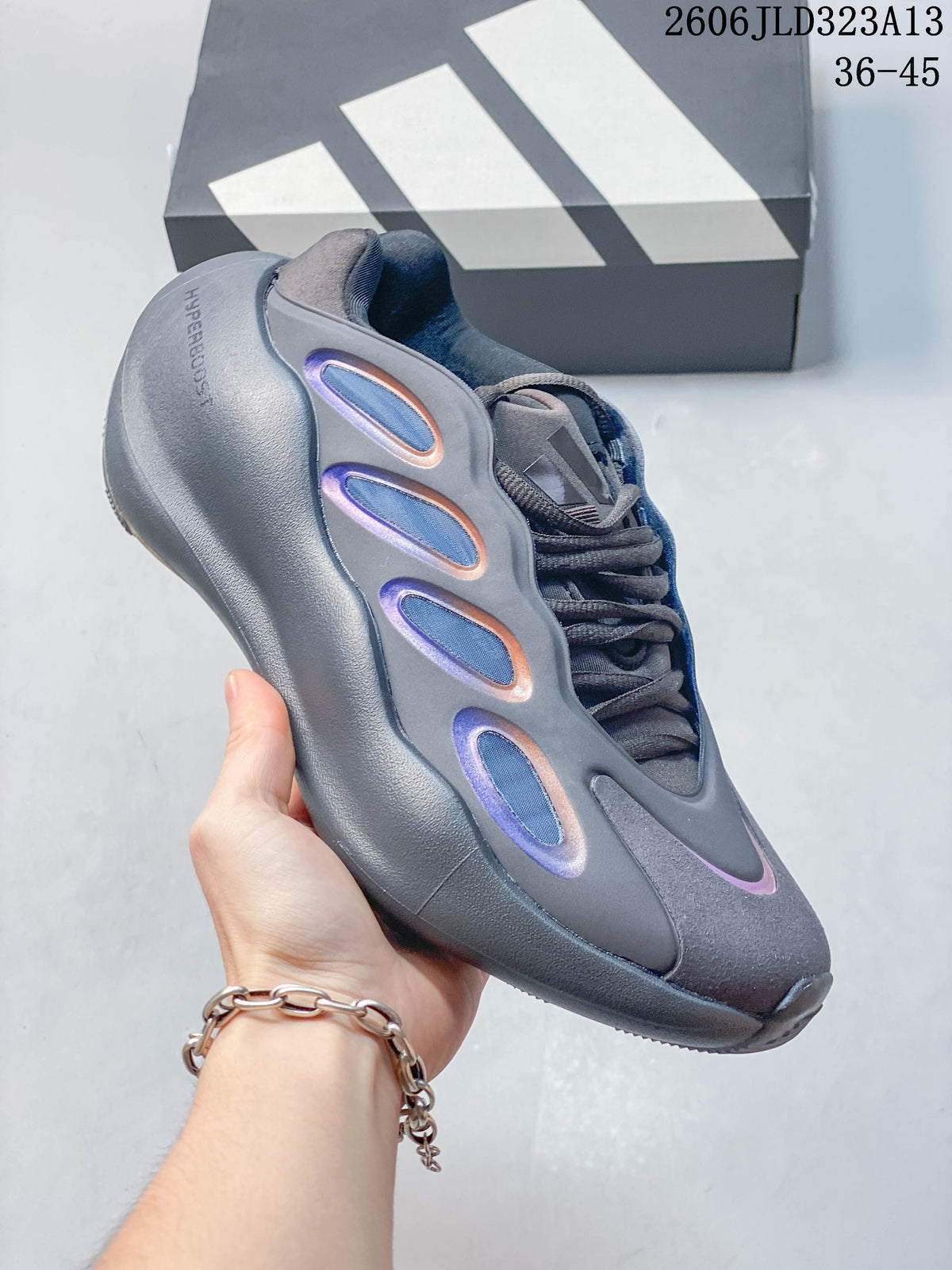 Angled side view of the gray sneaker with a sculpted sole and colored side details.