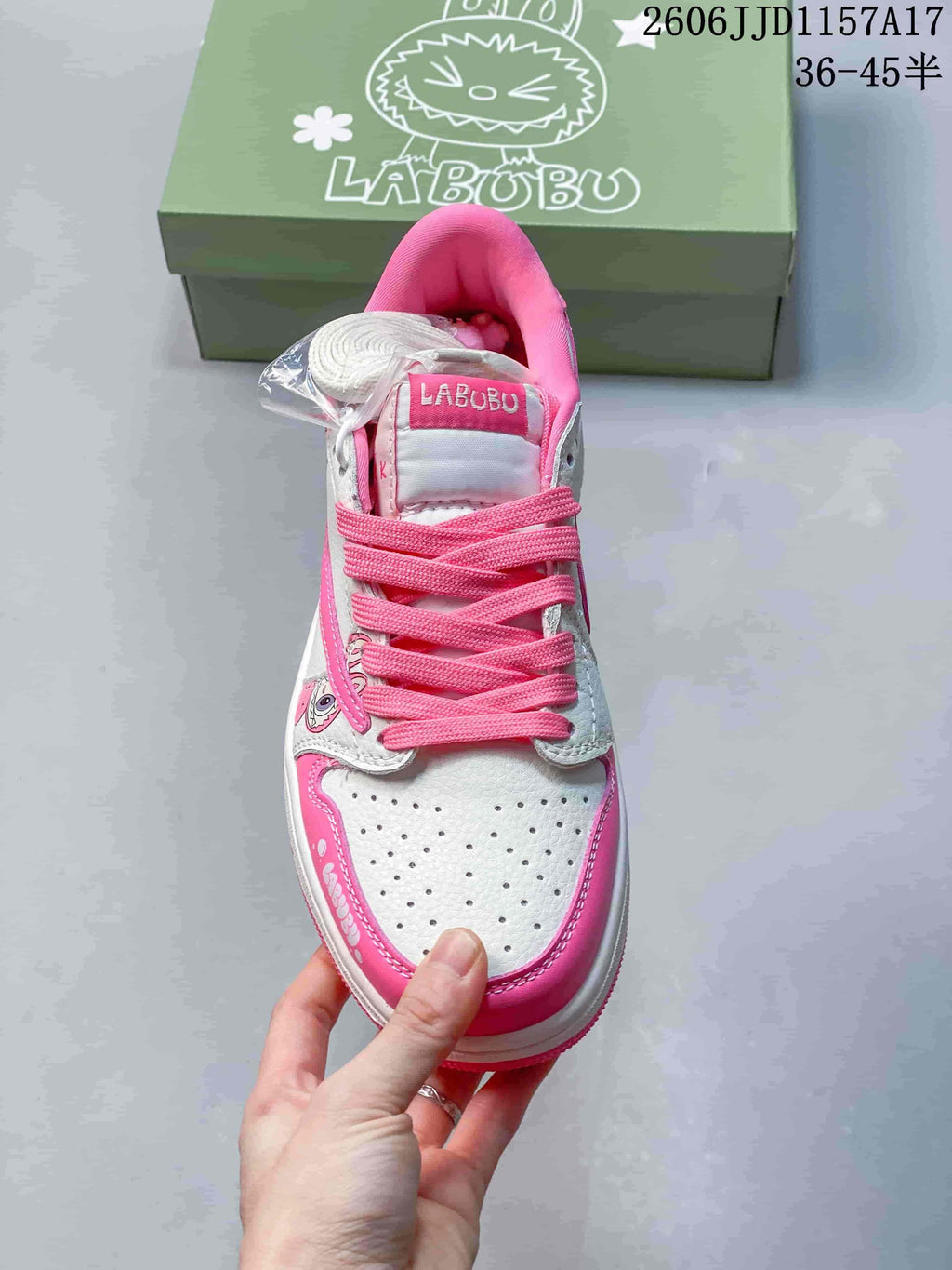 Top view showing pink laces, perforated toe, and character details