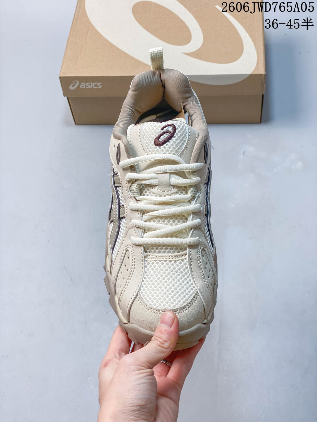 Top view of the mesh panels and laces on a cream ASICS Gel-TRUCK sneaker