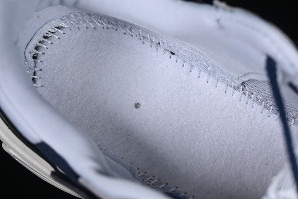 Close-up of the light-colored shoe lining and stitching