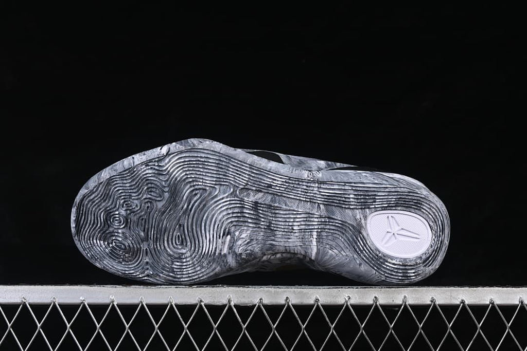 Underside view of the marbled gray outsole and tread