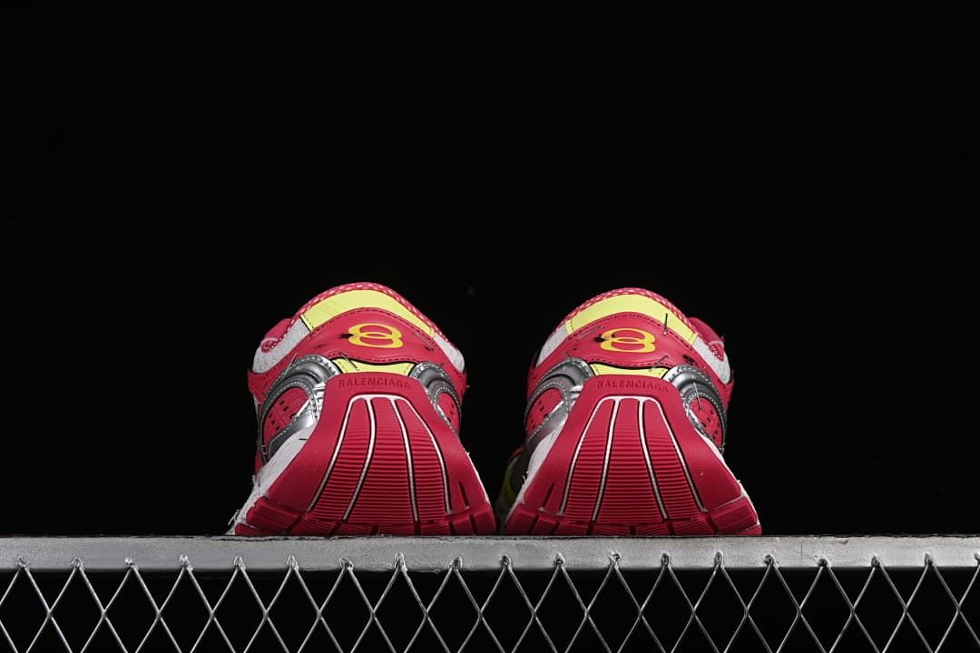 Rear view of both sneakers showing pink heels and segmented soles