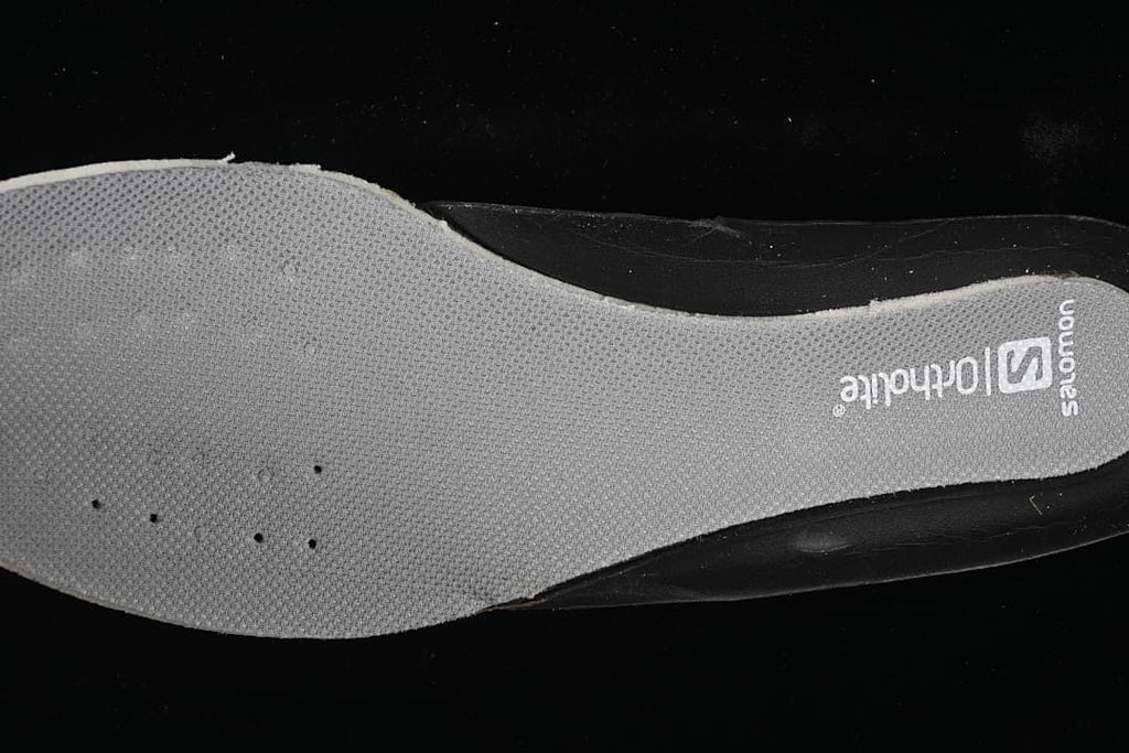 Close-up of gray shoe insole with Salomon branding