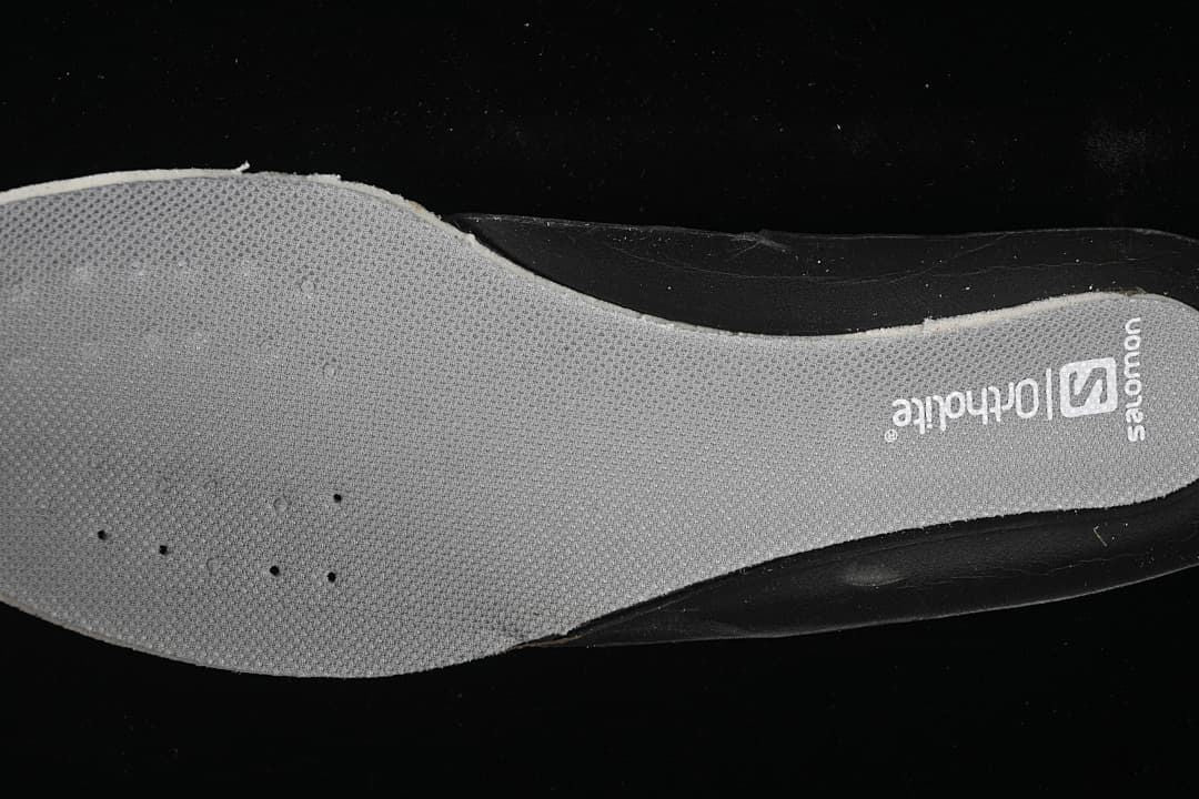 Close-up of gray shoe insole with Salomon branding