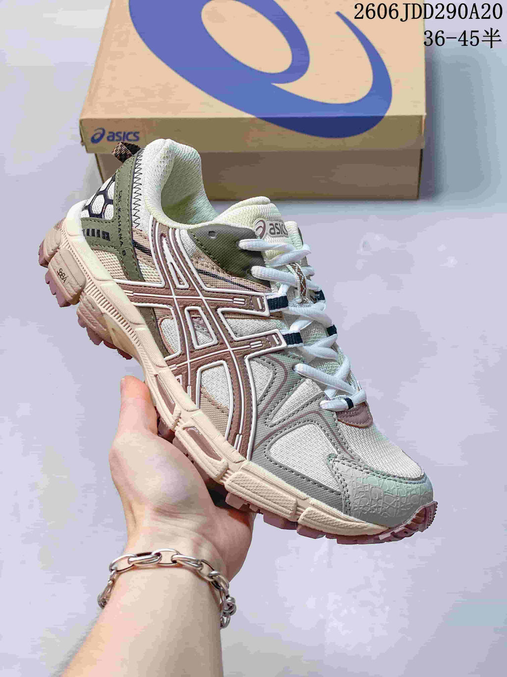 Close-up of a light-colored ASICS Gel-Kahana 8 sneaker with olive and muted pink details.