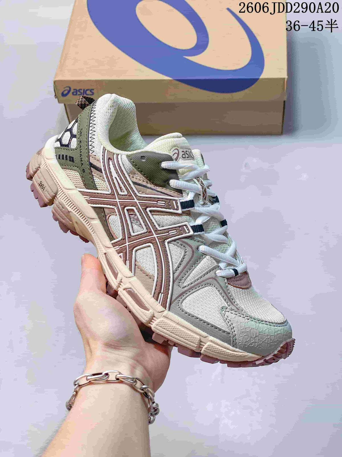 Close-up of a light-colored ASICS Gel-Kahana 8 sneaker with olive and muted pink details.