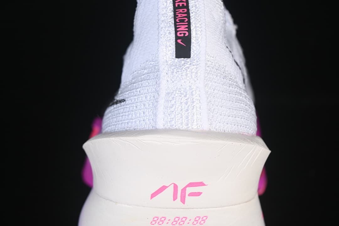 Rear view of the white shoe with pink Alphafly branding.