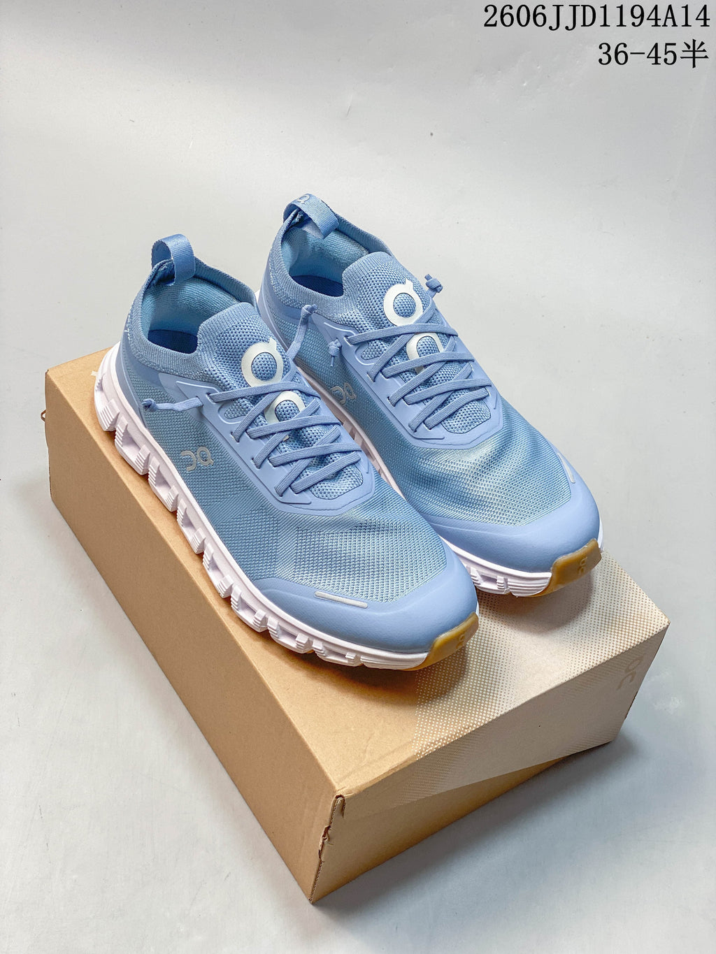Pair of blue On Cloud 6 Versa sneakers on a box, showing the front and side.