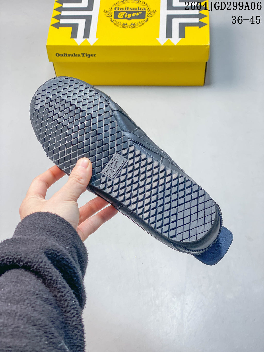 Close-up of the patterned outsole on a charcoal gray sneaker