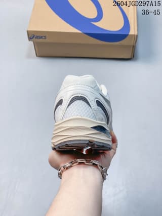 Rear view of the white ASICS Gel-Flux CN shoe showing the heel structure and layered midsole.