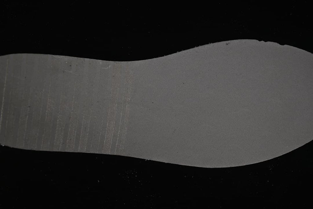 Underside of a sneaker insole shown against a dark background