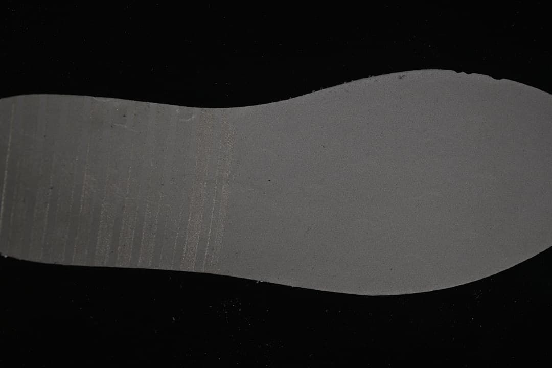 Underside of a sneaker insole shown against a dark background