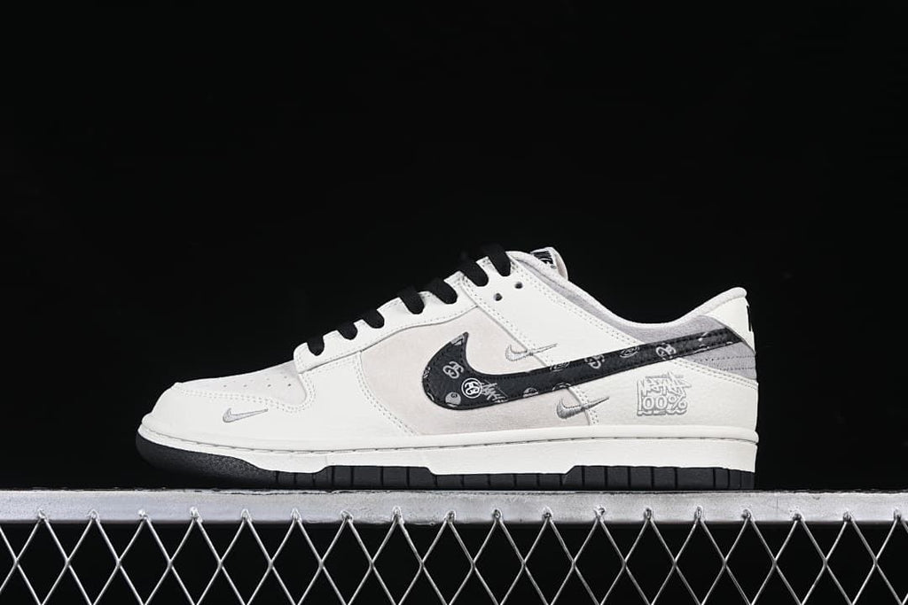 Side view of one sneaker with a patterned black Swoosh and white-gray upper