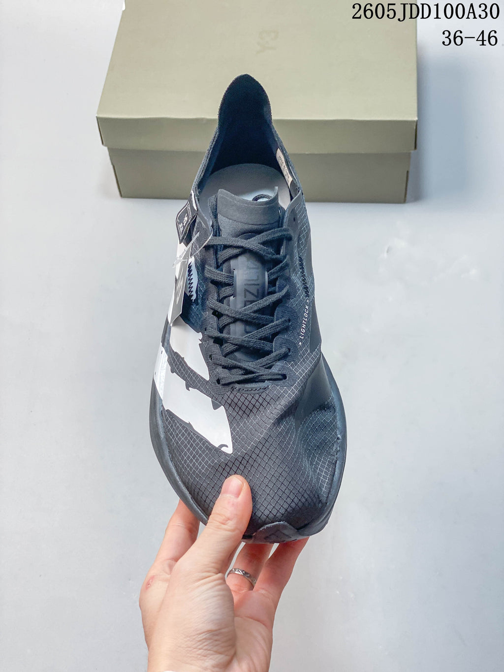 Front view of a gray lace-up running shoe with a patterned upper