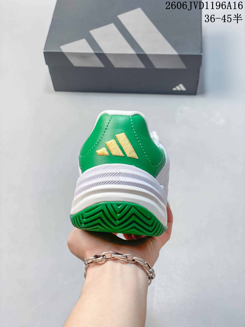 Rear view of the shoe with a green heel panel and gold-tone logo.